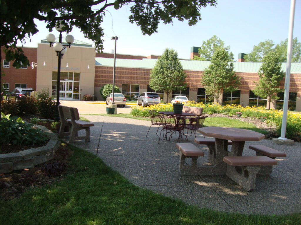patio with tables, chairs, and a bench